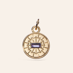 Gold and Purple Crystal Charm on Tan Background