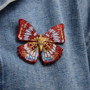 Red and Pruple Multi Beaded and Embroidered Butterfly Brooch Staged on a Denim Jacket