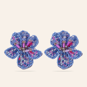 Blue and Purple Beaded Flower Stud Earrings on Tan Background