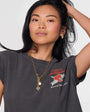 Mondel wearing gold studs and necklace