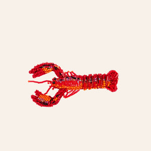 Red Beaded Lobster Brooch on Tan Background