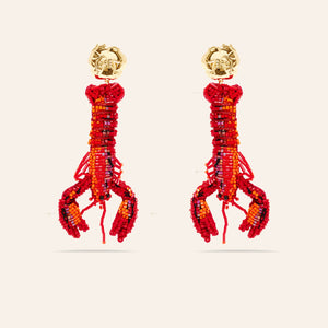 Red Beaded Lobster Drop Earrings on Tan Background