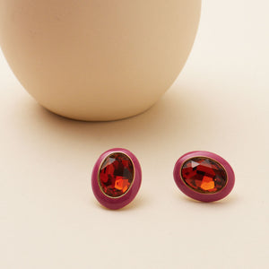 Crystal and Enamel Stud Earrings Styled on Cream Surface with Vase in Background