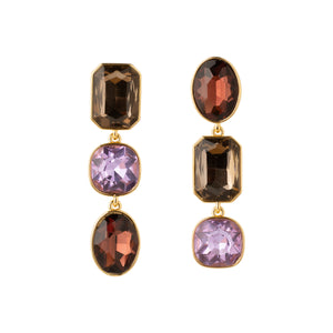 Brown, Red, and Purple Drop Earrings on Tan Background on Flat White Background