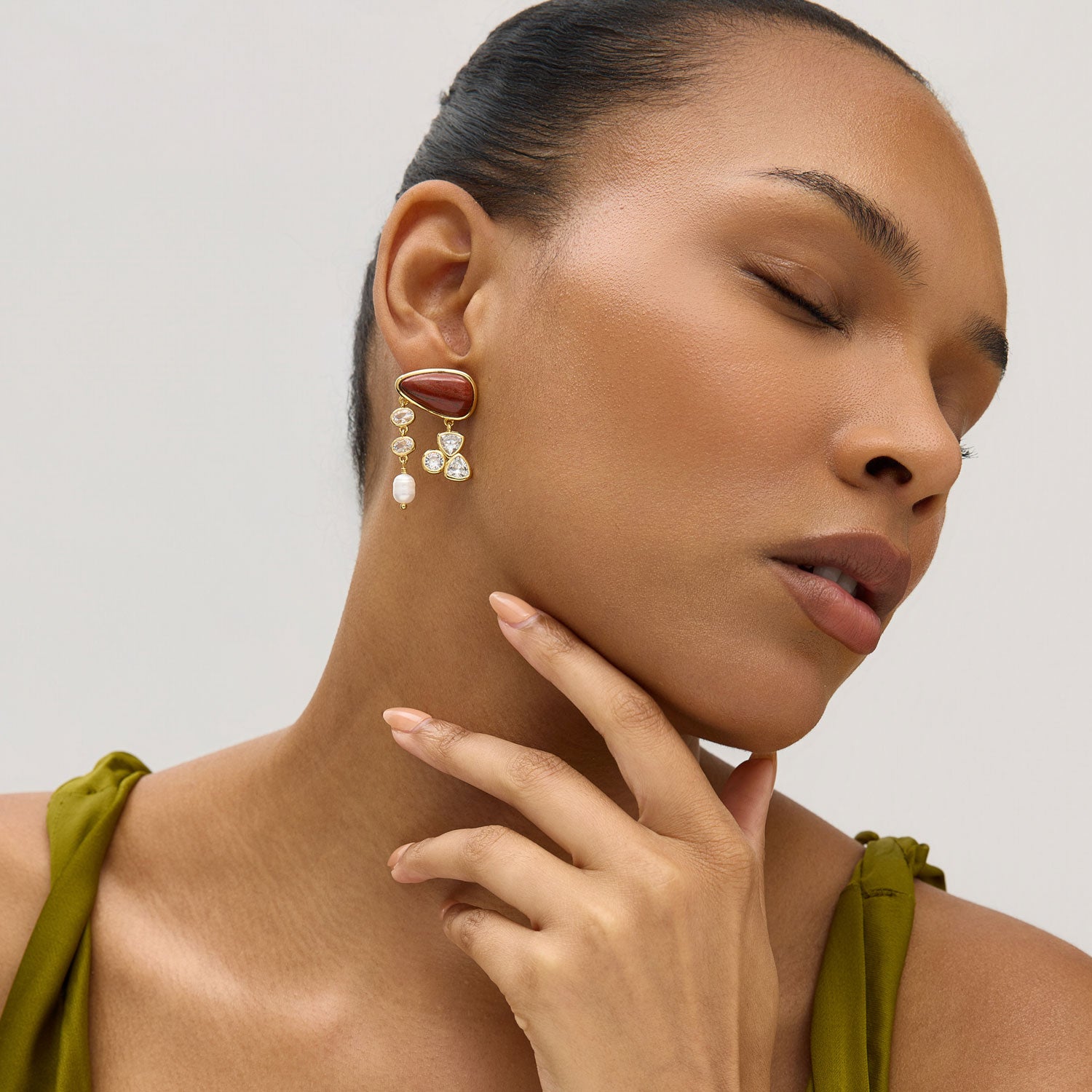 Woman wearing earrings with a neutral background