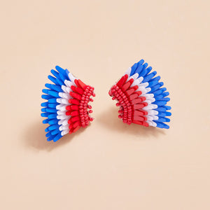 Red, White, and Blue Sequin and Bead Wing Stud Earrings on Tan Background