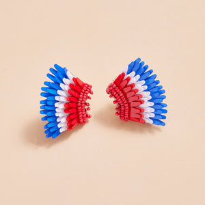 Red, White, and Blue Sequin and Bead Wing Stud Earrings on Tan Background