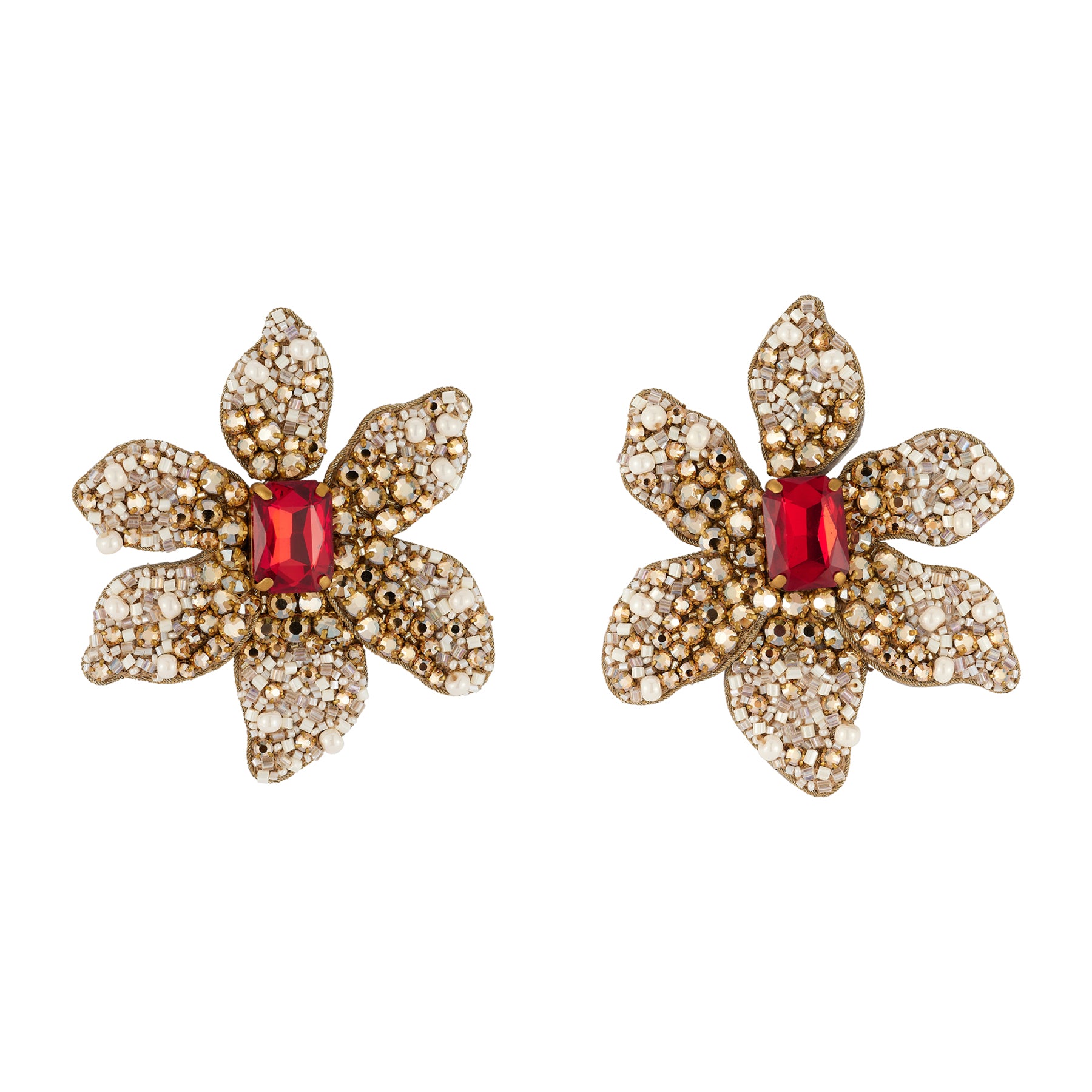 Pair of gold flower-shaped earrings with a red center on a white background