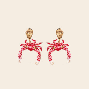 Red and White Beaded and Embroidered Crab Drop Earrings on Tan Background