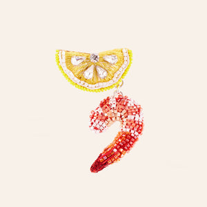 Yellow and Red Beaded Lemon Wedge and Shrimp Cocktail Brooch on Tan Background