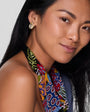 Model wearing gold studs with beaded scarf necklace.