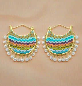 Multi-Colored Sequin, Pearl, and Gold Hoop Earrings Styled on Cream Background
