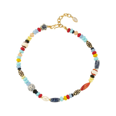 A colorful beaded necklace with a gold-tone clasp, featuring a variety of small beads in red, light blue, yellow, white, black, and patterned designs, displayed on a clean white background.