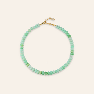 Green Beaded Strand Necklace on Cream Background