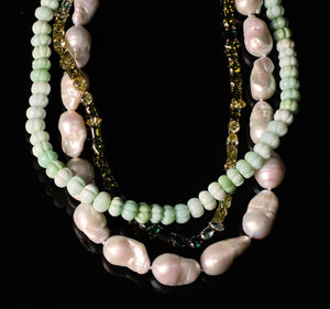 Green Beaded Strand Necklace Staged with White Pearl Necklace and Green Crystal Tennis Necklace with Black Background