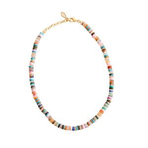 Multi-colored beaded strand necklace on flat white surface