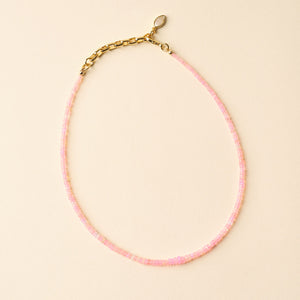 Pink Beaded Strand Necklace on Tan Background