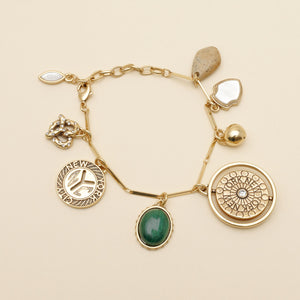 Stone, Gold, and Pearl Charm Bracelet on Cream Background