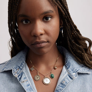 Gold, Stone, and Pearl Charm Necklace Styled on Model