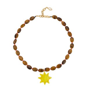 Brown and Coral Beaded Necklace with Yellow Glass Sun Charm Pendant Necklace on Flat White Background