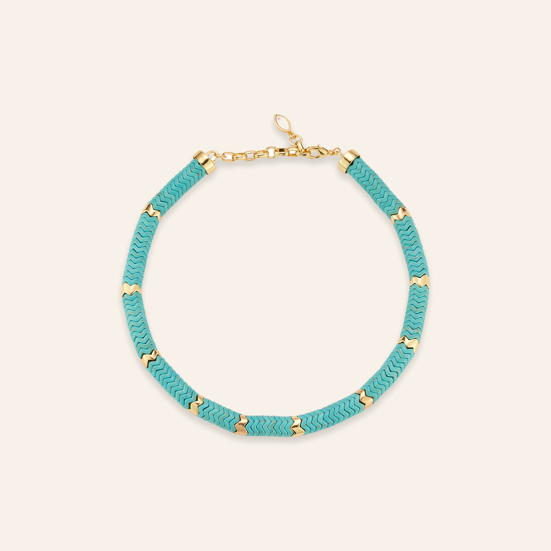 Turquoise and Gold Beaded Strand on Tan Background