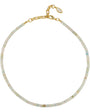 A delicate beaded necklace with small iridescent beads in pale blue, green, and cream tones, accented by a gold-tone chain and lobster clasp with a small teardrop charm.