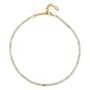 A delicate beaded necklace with small iridescent beads in pale blue, green, and cream tones, accented by a gold-tone chain and lobster clasp with a small teardrop charm.