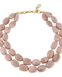 A double-strand necklace featuring irregular, polished pinkish-beige stone beads with natural marbled textures, secured by a gold-tone chain and lobster clasp with a small white inlay accent.