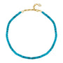 A turquoise beaded necklace with a gold clasp and a small white oval tag, displayed on a clean white background.