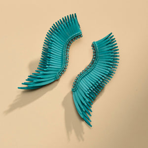 Turquoise and Teal Sequin and Bead Wing Stud Earrings on Flat Tan Surface