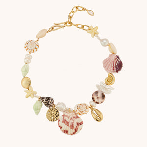 Shell, Pearl, and Bead Collar Necklace on Tan Background