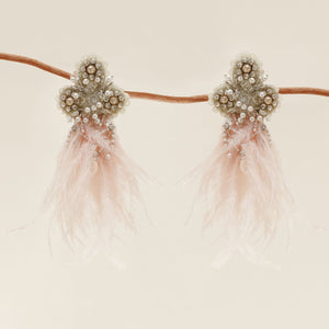 Silver Beaded and Embroidered Pink Feather Drop Earrings Staged on Branch with Cream Background