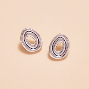 Organic Silver Studs on Tan Background