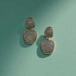 Pave Crystal and Gold Double Drop Earrings on Green Surface