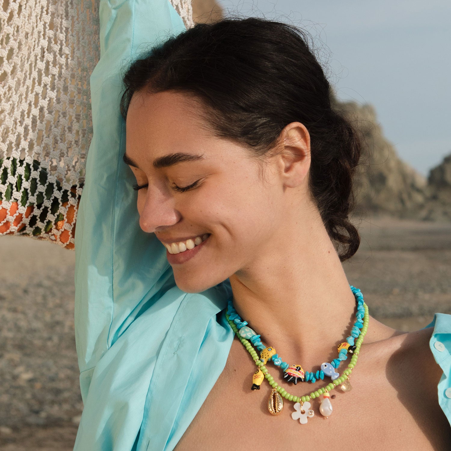 Blue Beaded Strand with Multi Colored Painted Fish Charms Styled on Model