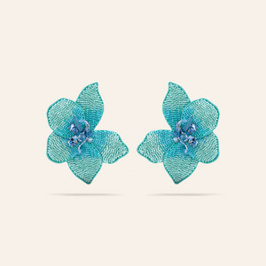 Turquoise Bead and Crystal Flower Stud Earrings on Tan Background