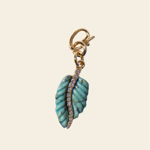 Turquoise Leaf Charm on Tan Background