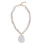 White shell shaped pendant on semi precious stone necklace