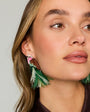 Model wearing bird embroidered statements earrings against a white background