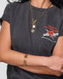Model wearing gold chain necklace against white background