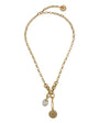 A gold chain necklace with a lobster clasp, featuring two hanging charms: a small oval white stone charm and a larger circular sunburst-patterned gold charm, displayed on a clean white background.
