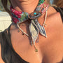 Model wearing a bandana necklace with a scarf ring around the front