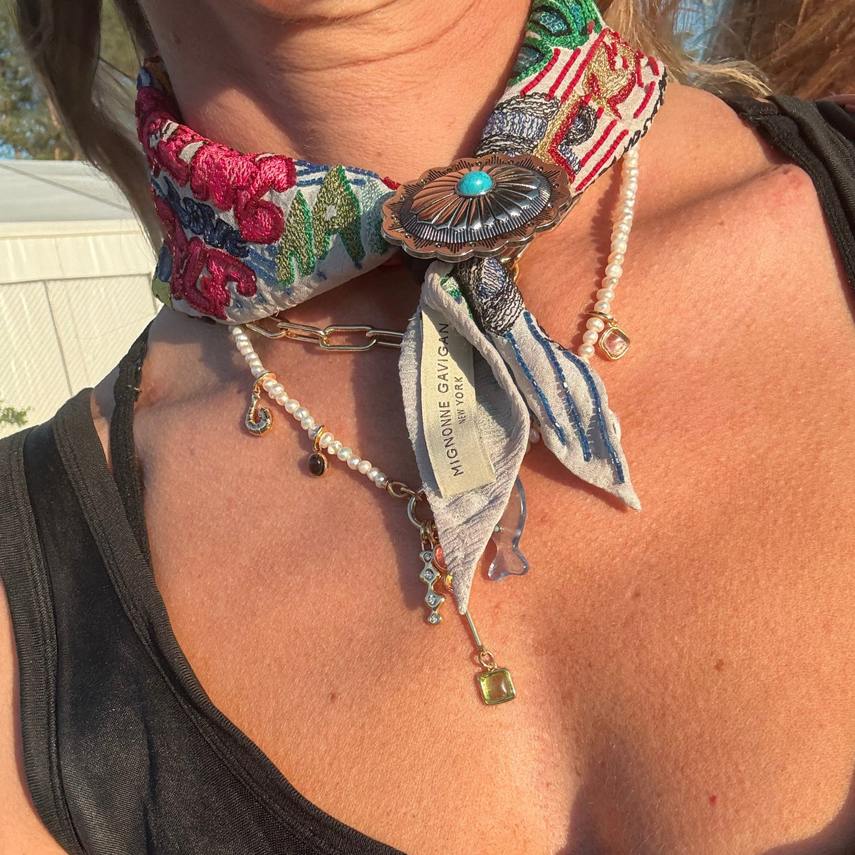 Model wearing a bandana necklace with a scarf ring around the front
