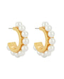 Gold hoop earrings with pearl beads on a white background