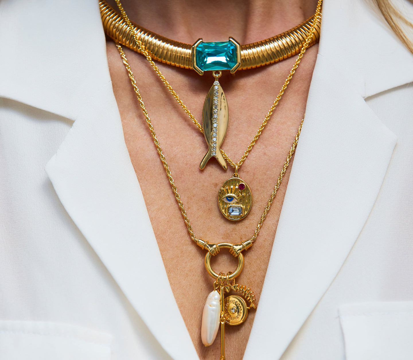 Gold necklaces with various pendants on a white background