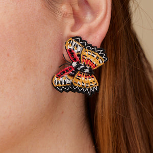 Embroidered Red, Orange, Black, and White Butterfly Stud Earrings on Model's Ear