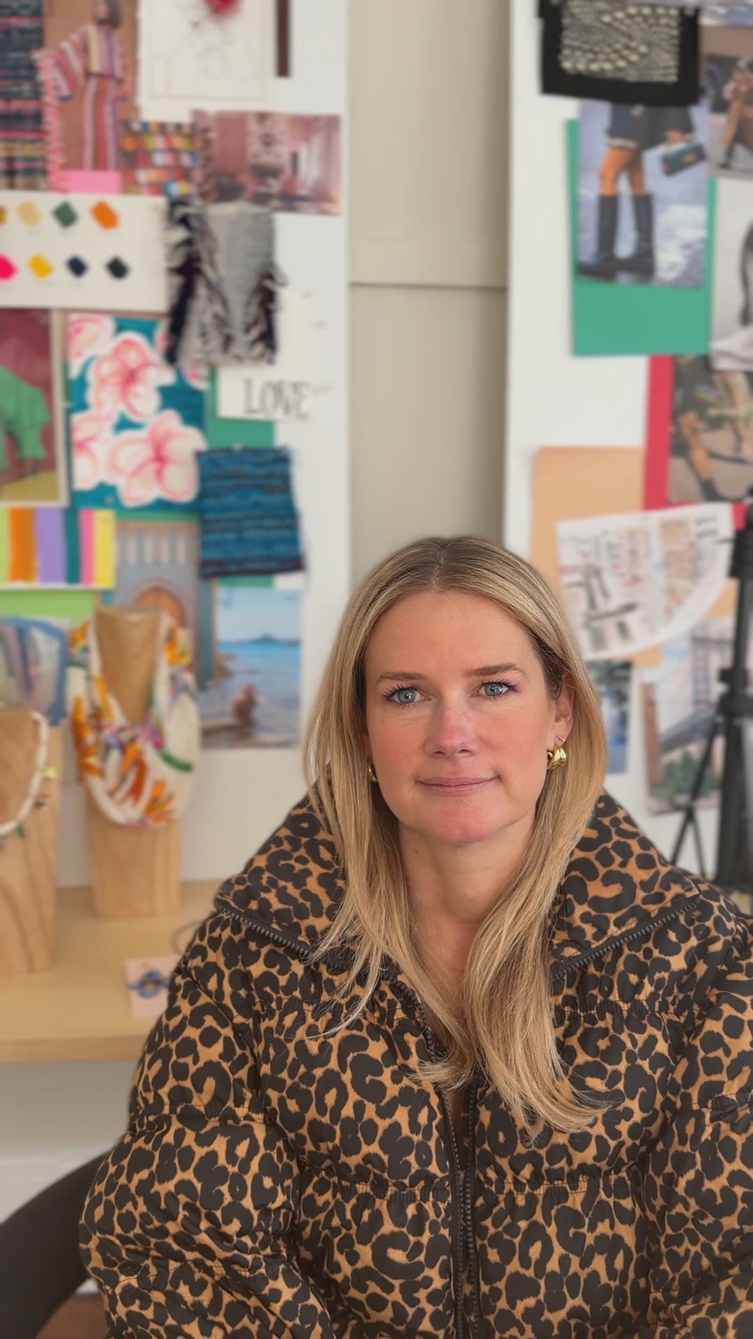 Model wearing gold hoop earrings in cheetah jacket.