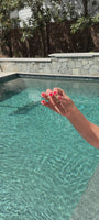 Model next to a pool explaining the significance behind a palm tree shaped earring stud