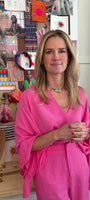 Model wearing pink long sleeve top and pants explaining green mother of pearl choker necklace