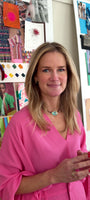 Model wearing pink top with gold stud earrings and iridescent green choker necklace